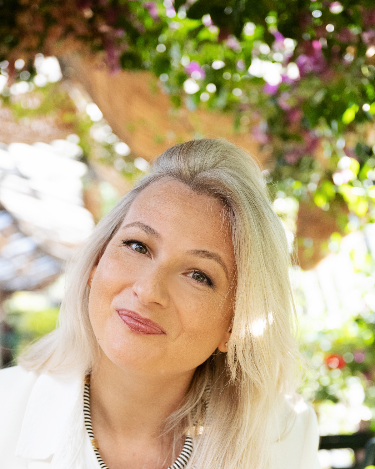 Portrait of Elizabeth Adams at a garden cafe