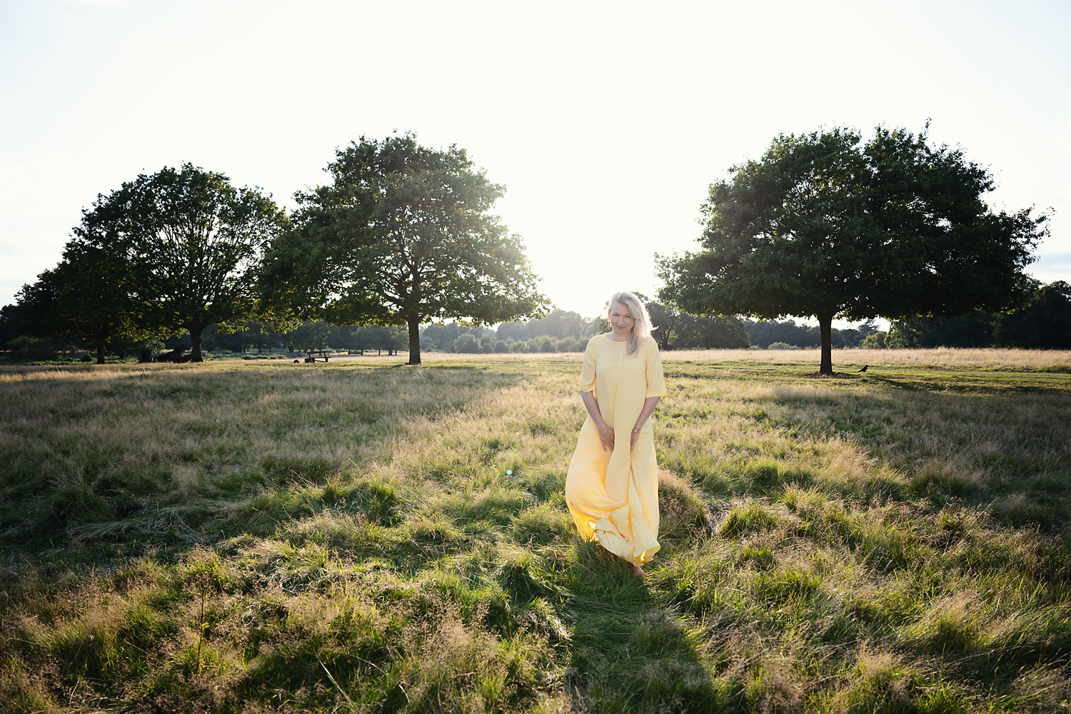 Elizabeth Adams walking through a meadow below Richmond